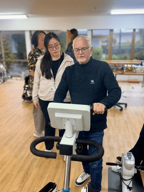 Resident using movement therapy equipment with a physiotherapy staff member at Knox